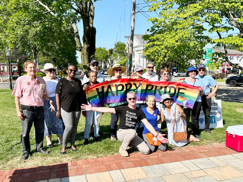 Members of the BCCR Flags Subcommittee pose with a banner saying, "Happy Pride."