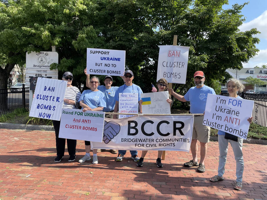 BCCR members hold signs saying, 