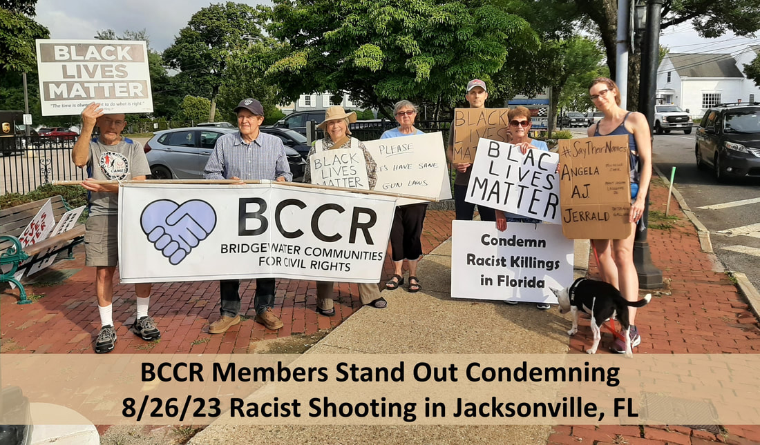 BCCR members hold signs saying, 