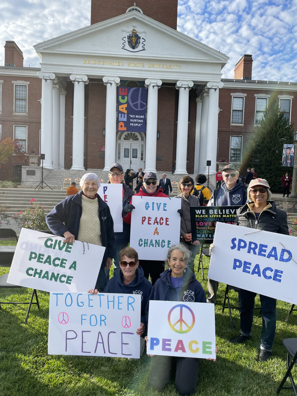 Some members from BCCR held signs at the 10/24/23 Peace Vigil at Bridgewater State University. Signs read, 