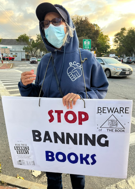 BCCR member holds sign saying, "Stop banning books."