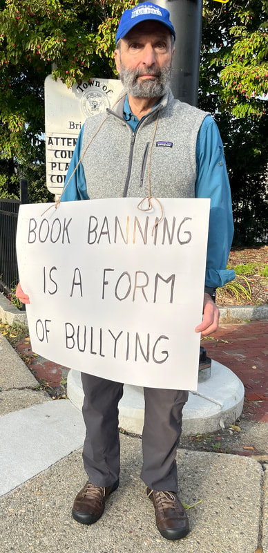 BCCR member holds a sign that says, "Book banning is a form of bullying