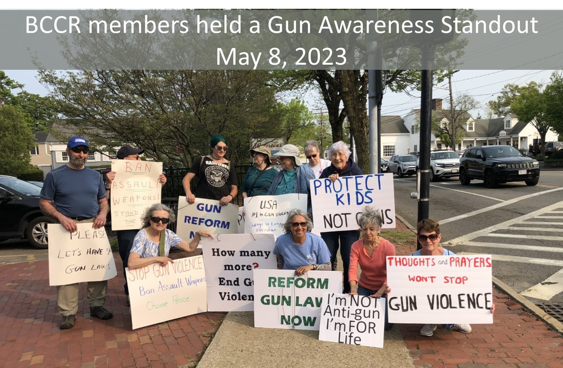 BCCR members held a gun awareness standout May 8, 2023. Members' signs say things like: 